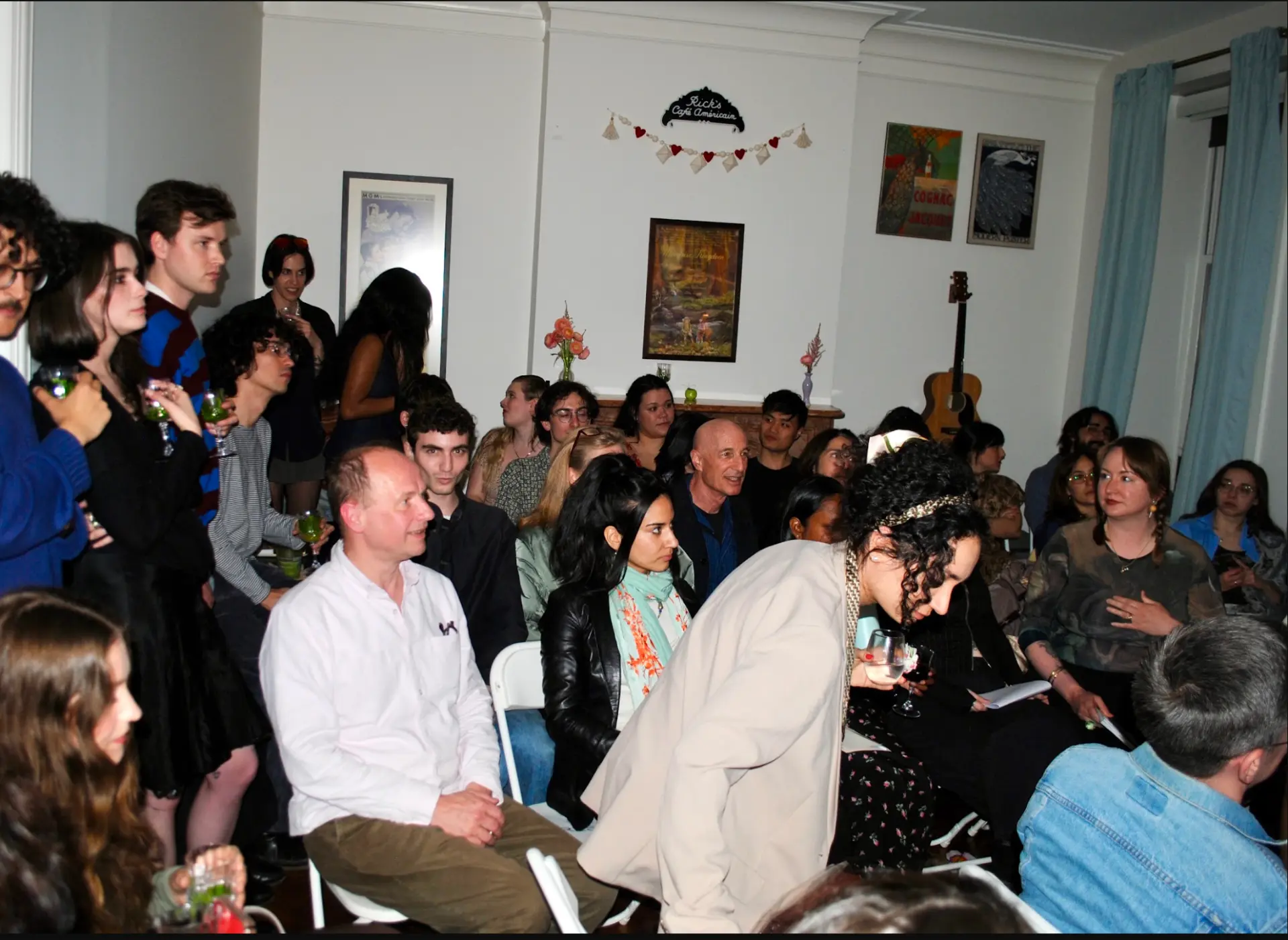 Audience seated and listening at a poetry reading